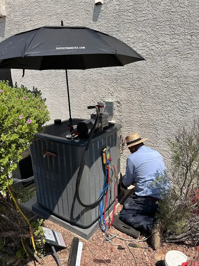 HVAC technician performing outdoor AC maintenance in Lockhart